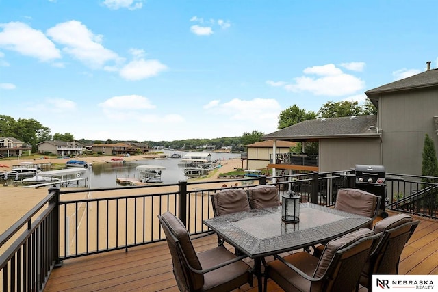 wooden deck featuring outdoor dining space and a water view