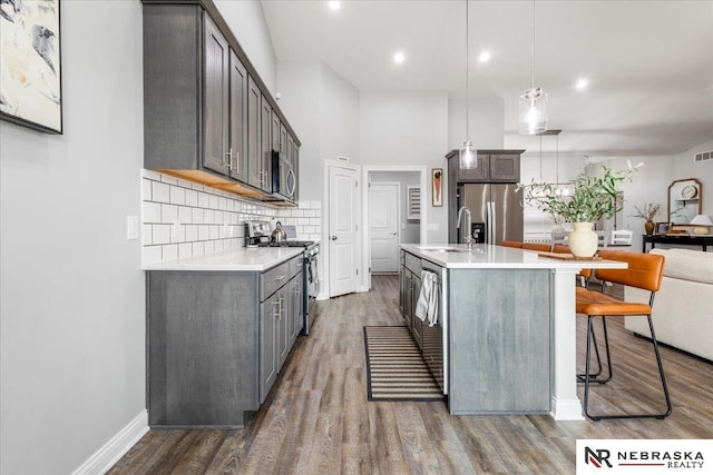 708 Sunset Blvd, Palmyra, NE 68418 - kitchen with appliances with stainless steel finishes, light countertops, a sink, dark wood finished floors, and recessed lighting