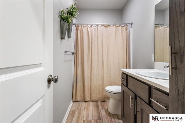 708 Sunset Blvd, Palmyra, NE 68418 - full bath with vanity, toilet, wood finished floors, and a shower with curtain