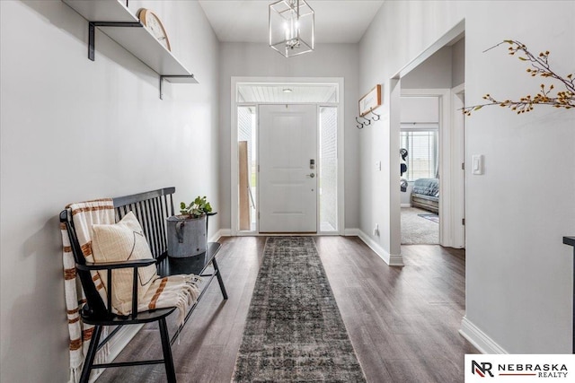 708 Sunset Blvd, Palmyra, NE 68418 - entrance foyer with dark wood-style floors, baseboards, and a chandelier