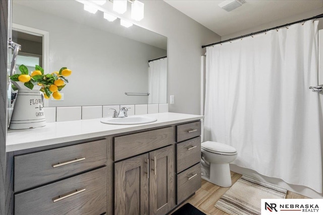 708 Sunset Blvd, Palmyra, NE 68418 - full bath with vanity, toilet, wood finished floors, and a shower with curtain
