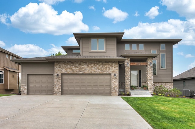 prairie-style home featuring central AC, a front yard, stone siding, and concrete driveway