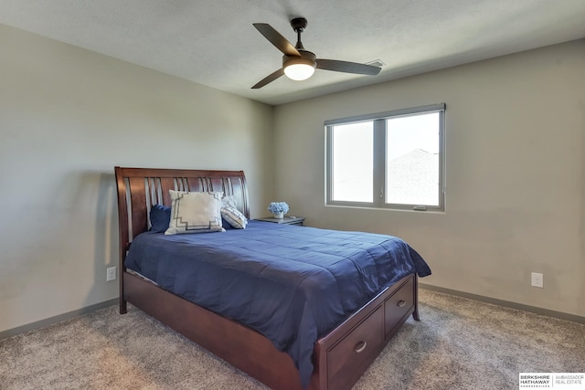 carpeted bedroom featuring baseboards and ceiling fan