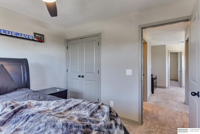 bedroom featuring a closet, carpet flooring, baseboards, and a ceiling fan