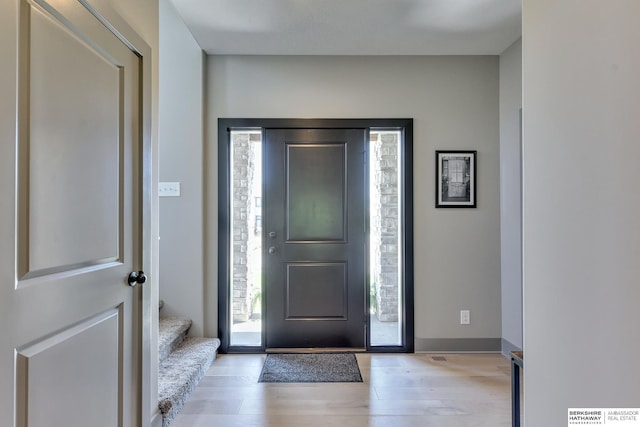 entryway with light wood finished floors and stairway