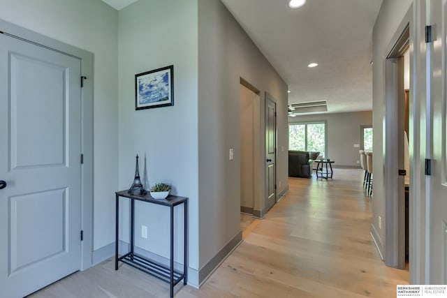 corridor with recessed lighting, baseboards, and light wood-type flooring