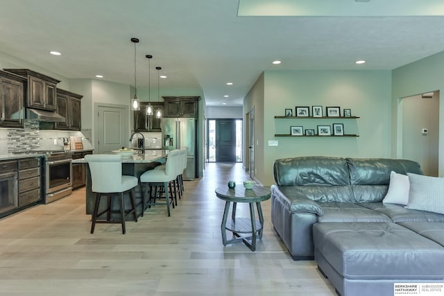 living room featuring recessed lighting and light wood-type flooring