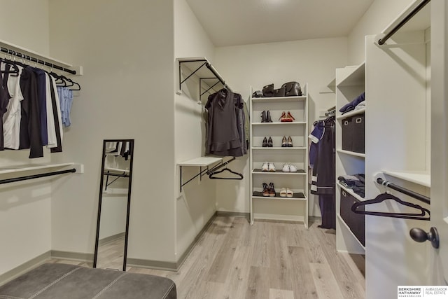 spacious closet featuring light wood-style flooring