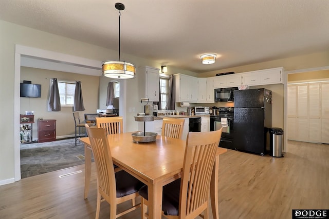 dining space featuring light wood finished floors