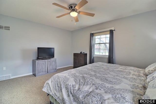 carpeted bedroom with visible vents, ceiling fan, and baseboards