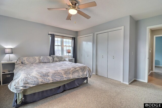carpeted bedroom featuring baseboards, a ceiling fan, and multiple closets