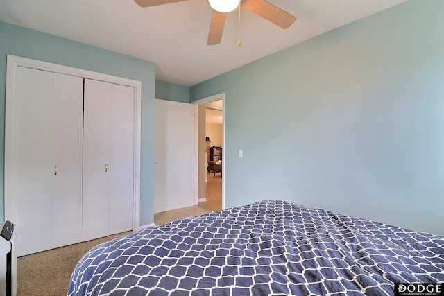 carpeted bedroom with a closet and a ceiling fan