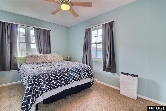 carpeted bedroom featuring baseboards and ceiling fan