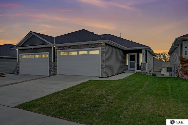 ranch-style house featuring stone siding, driveway, roof with shingles, a front yard, and an attached garage