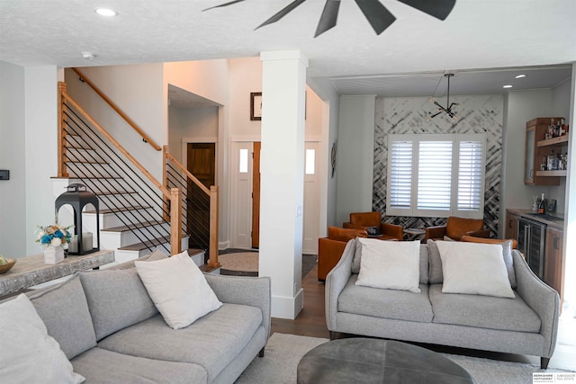 living room featuring recessed lighting, wood finished floors, ceiling fan, stairway, and wine cooler