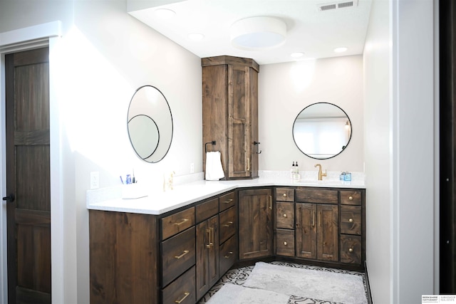 full bathroom with recessed lighting, double vanity, a sink, and visible vents