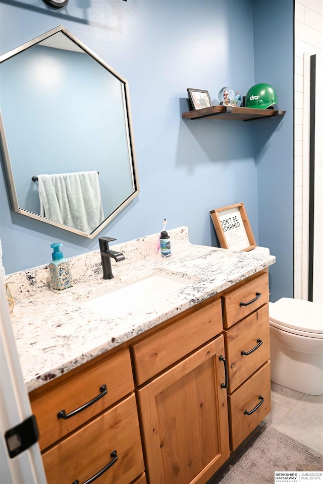 full bath featuring toilet, tile patterned flooring, and vanity
