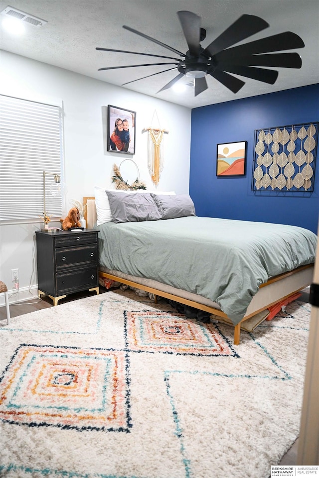 bedroom featuring visible vents and ceiling fan