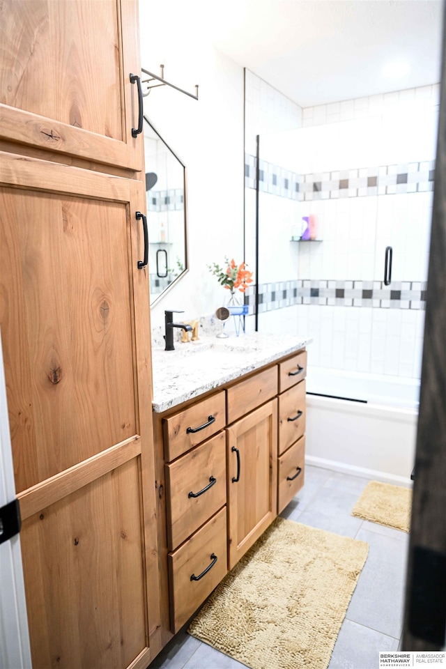 bathroom featuring washtub / shower combination, tile patterned flooring, and vanity