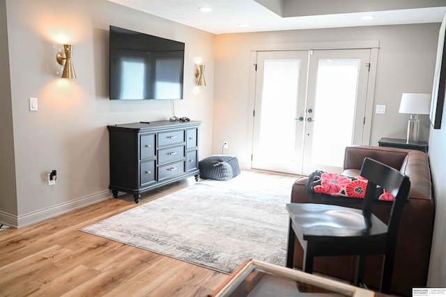 living area featuring wood finished floors, french doors, recessed lighting, and baseboards