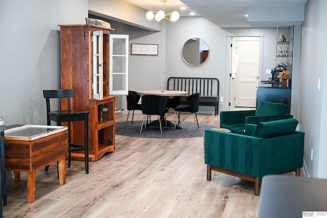 interior space with recessed lighting, an inviting chandelier, and light wood-style flooring