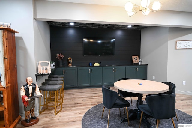 rec room featuring a notable chandelier, baseboards, and light wood-style floors