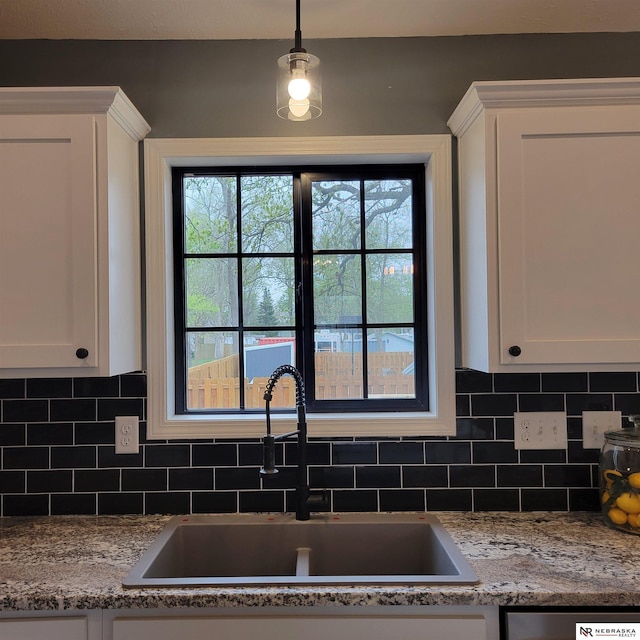 129 E 5th St, Valparaiso, NE 68065 - kitchen featuring a sink, white cabinets, backsplash, and dishwasher