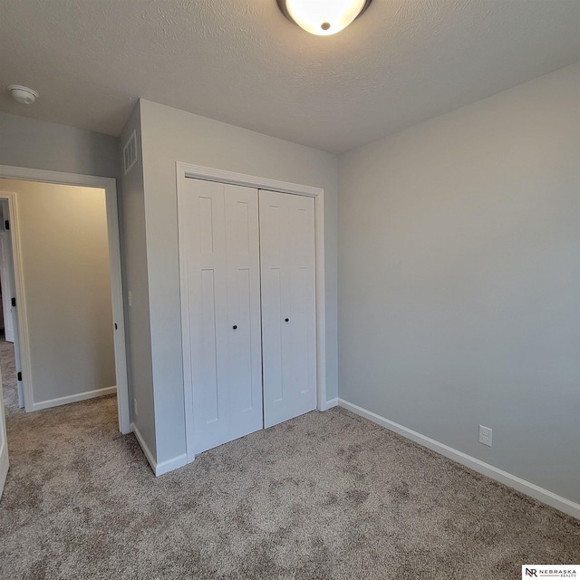 129 E 5th St, Valparaiso, NE 68065 - unfurnished bedroom featuring carpet floors, a closet, and baseboards