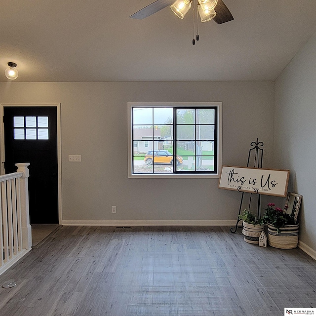 129 E 5th St, Valparaiso, NE 68065 - entryway featuring wood finished floors, ceiling fan, and baseboards