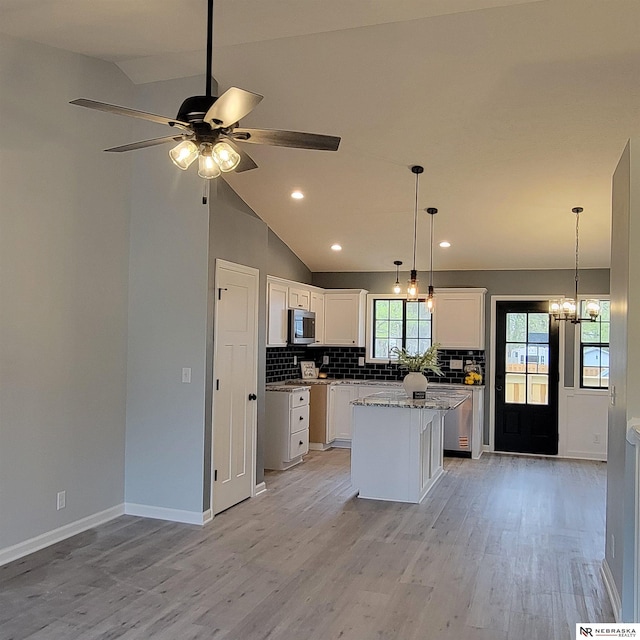 129 E 5th St, Valparaiso, NE 68065 - kitchen with stainless steel appliances, a ceiling fan, decorative backsplash, a kitchen island, and recessed lighting