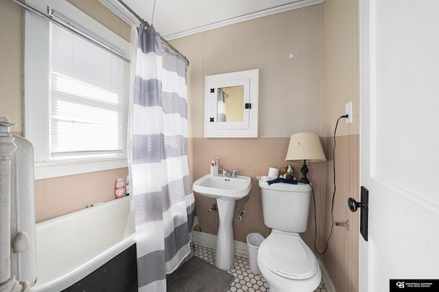 2406 J St, Lincoln, NE 68510 - bathroom with tile patterned floors, shower / bathtub combination with curtain, ornamental molding, and toilet