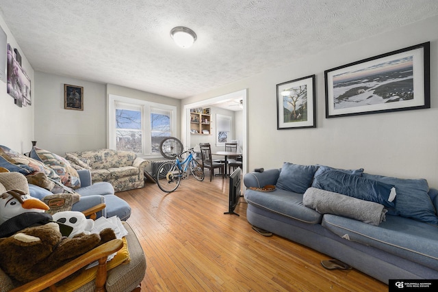 2406 J St, Lincoln, NE 68510 - living area featuring a textured ceiling and hardwood / wood-style floors