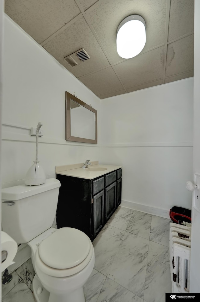 2406 J St, Lincoln, NE 68510 - bathroom with toilet, marble finish floor, visible vents, and vanity