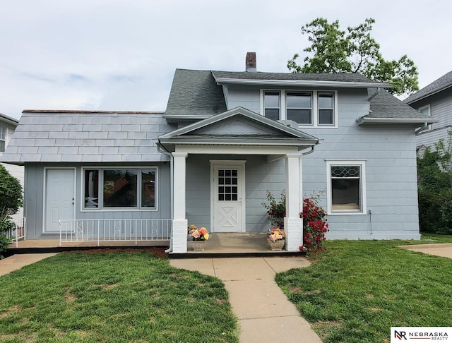 6512 Maple St, Omaha, NE 68104 - view of front of house with a chimney, a porch, and a front yard