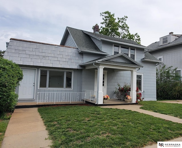 6512 Maple St, Omaha, NE 68104 - view of front of house featuring covered porch, a front yard, and a chimney