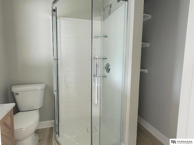 6512 Maple St, Omaha, NE 68104 - full bath with a shower stall, vanity, toilet, baseboards, and wood finished floors