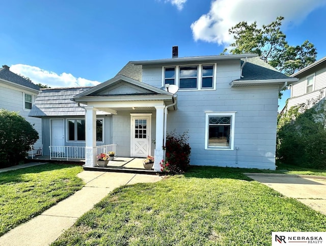 6512 Maple St, Omaha, NE 68104 - view of front of house with a porch, a chimney, and a front lawn