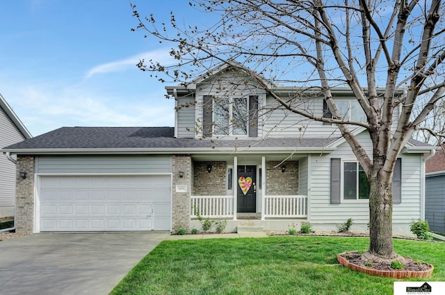 traditional-style home featuring covered porch, driveway, roof with shingles, a front yard, and an attached garage