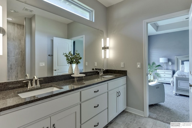 bathroom featuring visible vents, a sink, ensuite bath, and double vanity