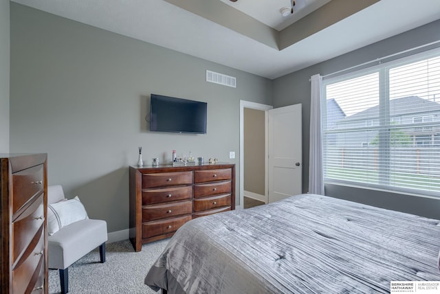 carpeted bedroom with visible vents and baseboards