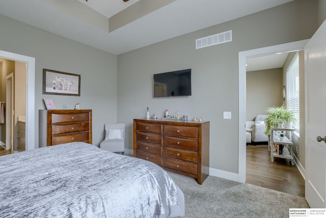 carpeted bedroom with visible vents and baseboards