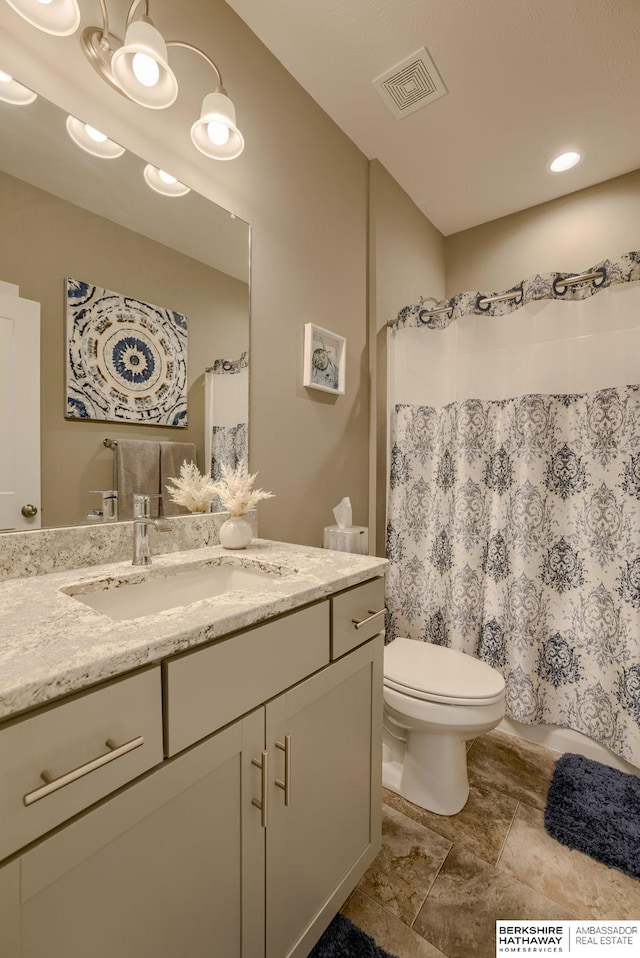 bathroom featuring visible vents, a shower with shower curtain, toilet, and vanity
