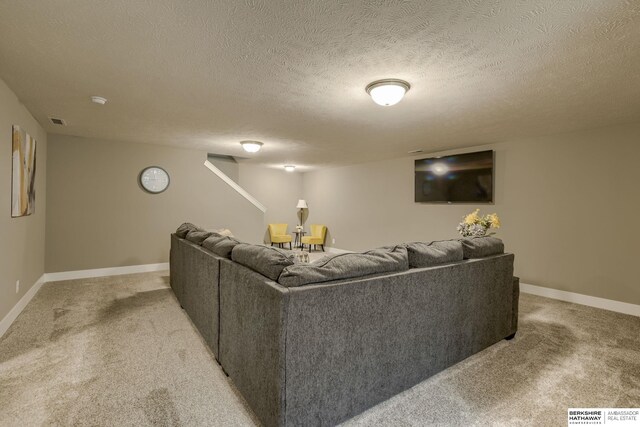 living room with light colored carpet, a textured ceiling, and baseboards