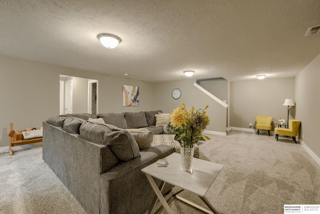 living area with light colored carpet, visible vents, a textured ceiling, and baseboards
