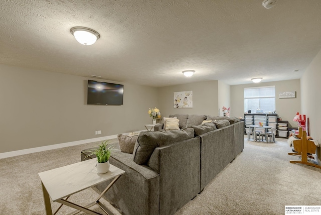 living area with light colored carpet, baseboards, and a textured ceiling