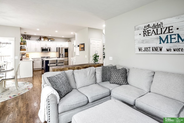 living area with recessed lighting and dark wood-type flooring