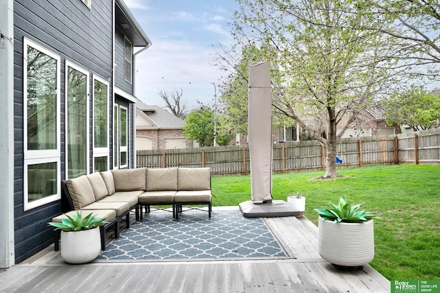 wooden terrace with an outdoor hangout area, a yard, and a fenced backyard