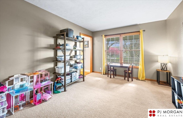 recreation room featuring baseboards and carpet