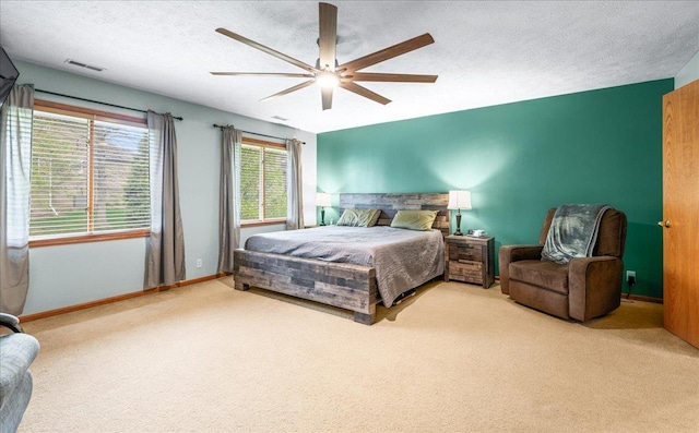 bedroom featuring visible vents, ceiling fan, baseboards, and carpet floors