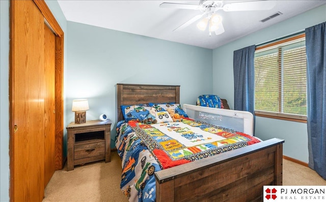 bedroom with a closet, carpet flooring, baseboards, visible vents, and a ceiling fan